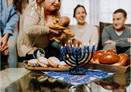 A table with some people and a menorah