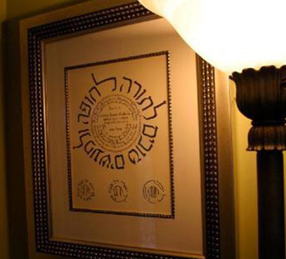 A framed picture of the hebrew alphabet on display.